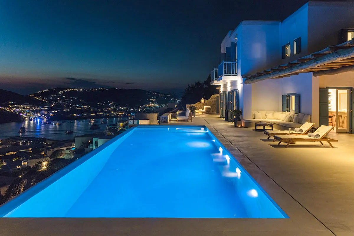 Sunlit private pool hotels villas advertising moment in Mykonos, Greece