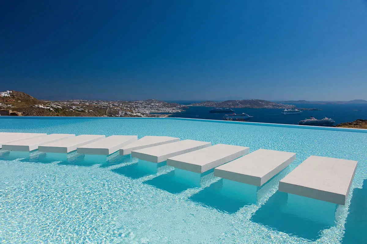 Sunlit private pool hotels villas advertising study in Mykonos, Greece