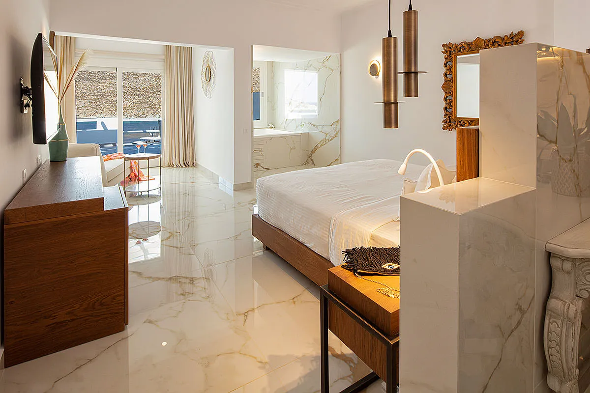 Sunlit stone lobby hotels villas advertising moment in Mykonos, Greece