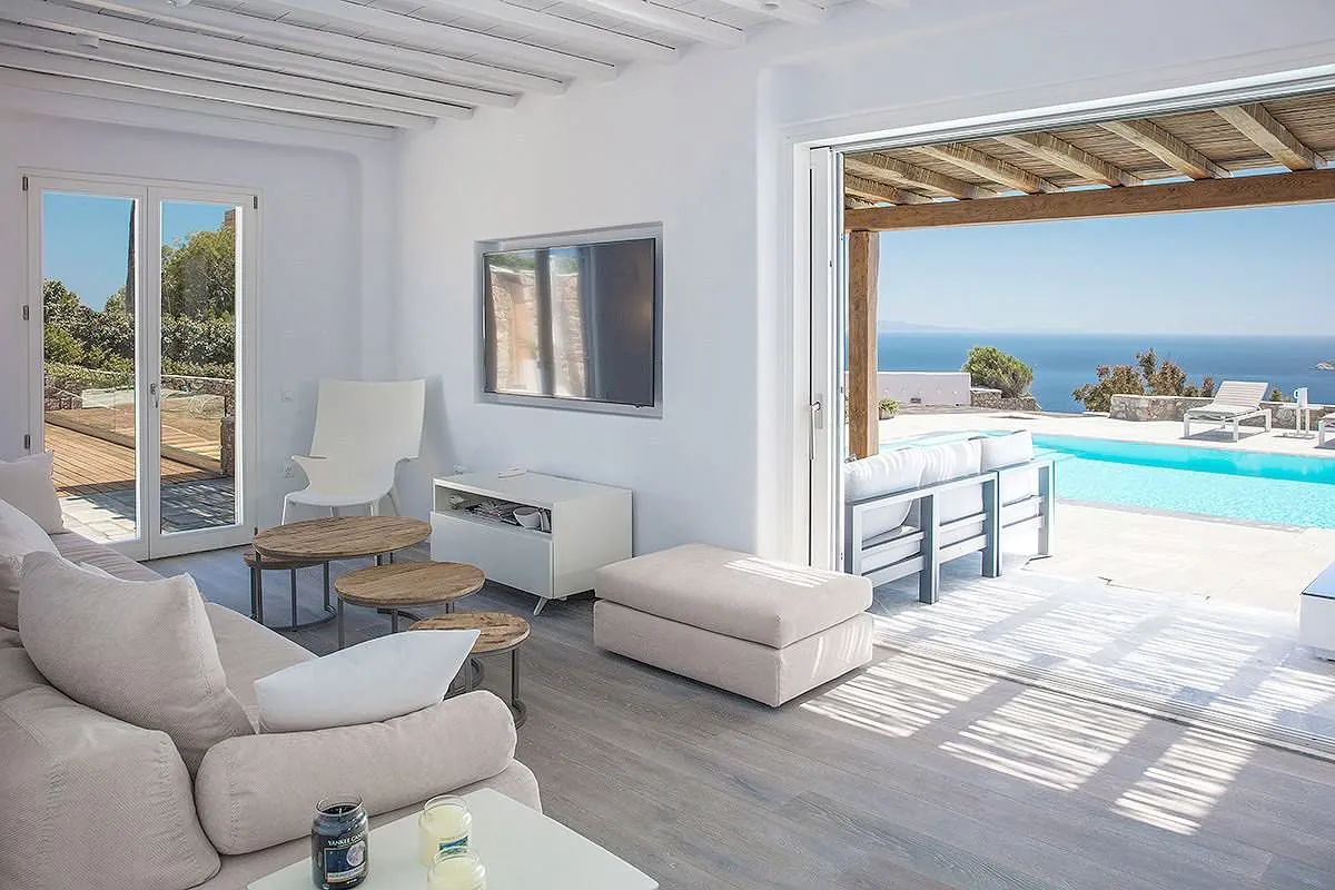 Sunlit sunset deck hotels villas advertising moment in Mykonos, Greece