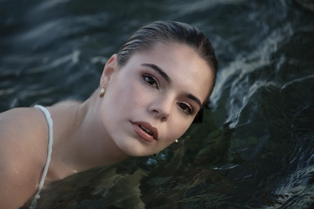 Soft-light Aegean swim portrait frame in Mykonos, Greece