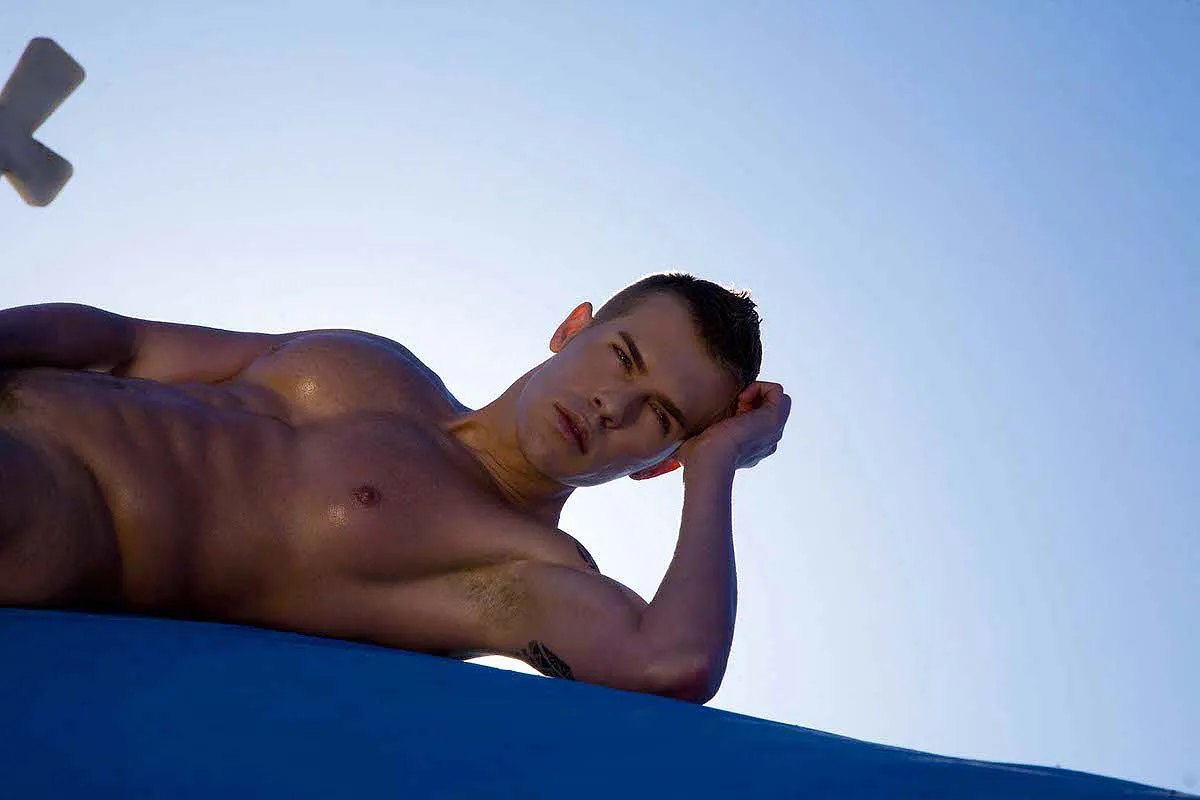 Soft-light bronze male sky portrait frame in Mykonos, Greece