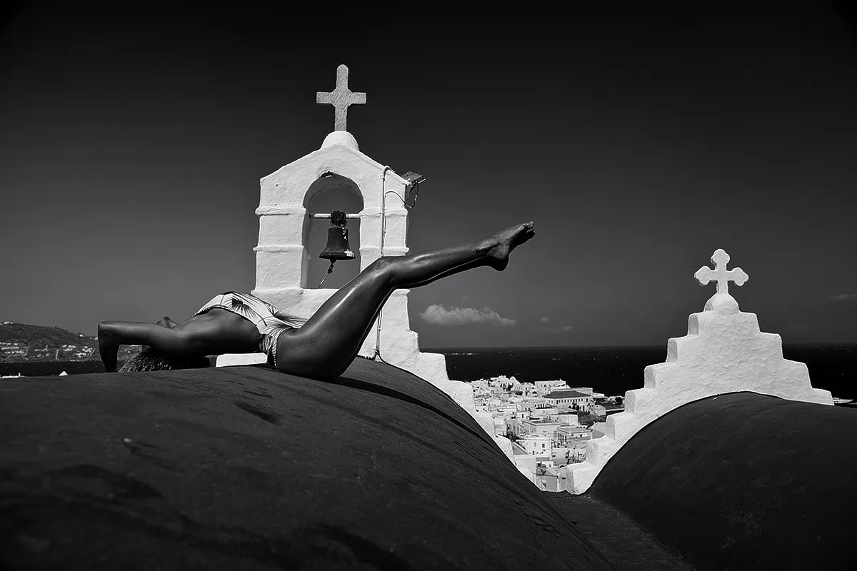Soft-light bronze male sky portrait composition in Mykonos, Greece