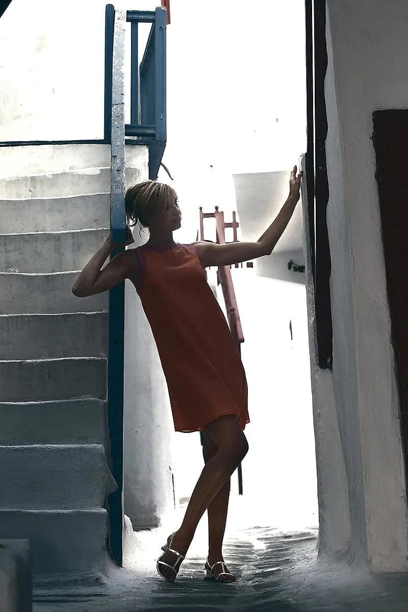 Soft-light surreal burning house editorial portrait moment in Mykonos, Greece