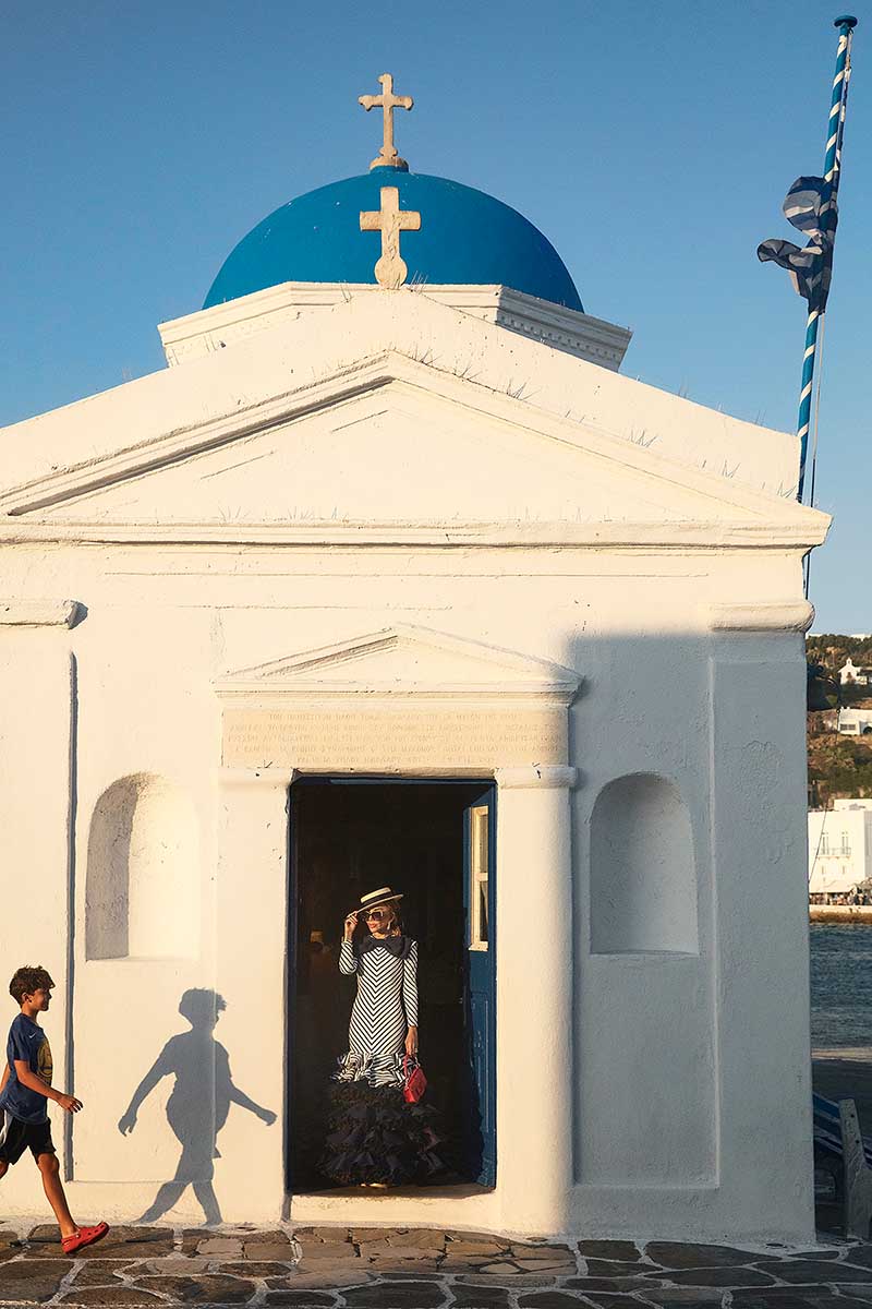 Soft-light engagement rooftop portrait view in Mykonos, Greece