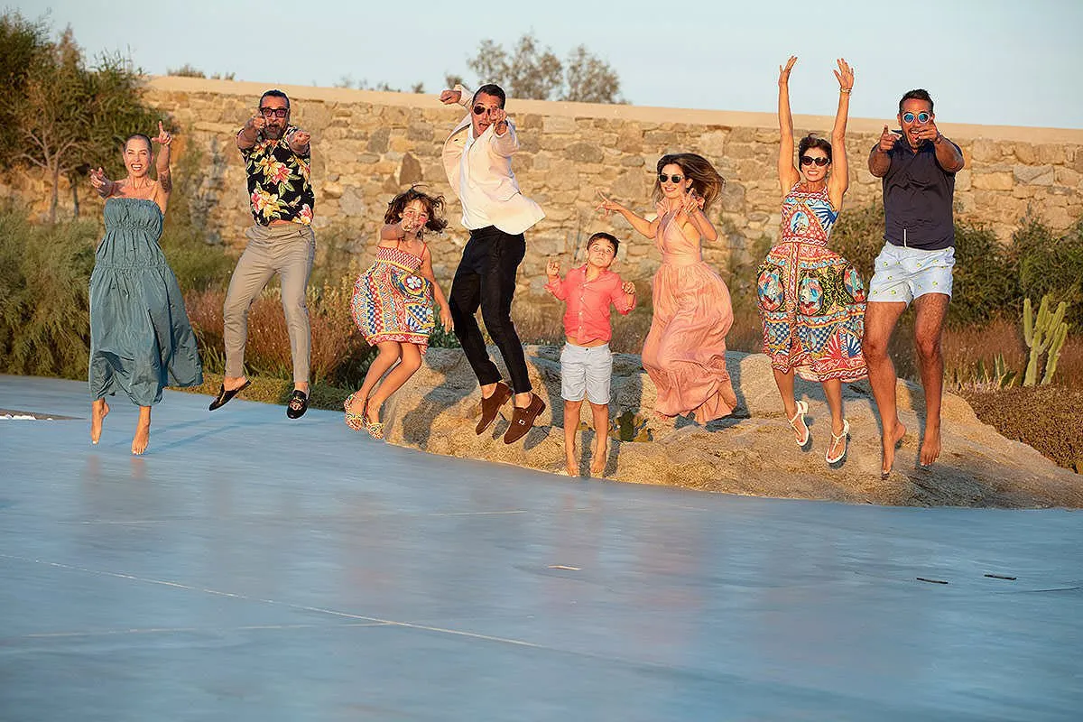 Soft-light family sunset jump portrait frame in Mykonos, Greece