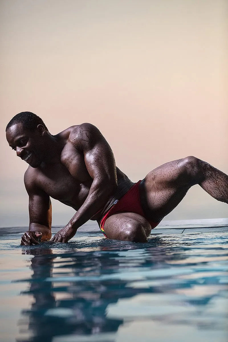 Soft-light athletic male pool portrait frame in Mykonos, Greece