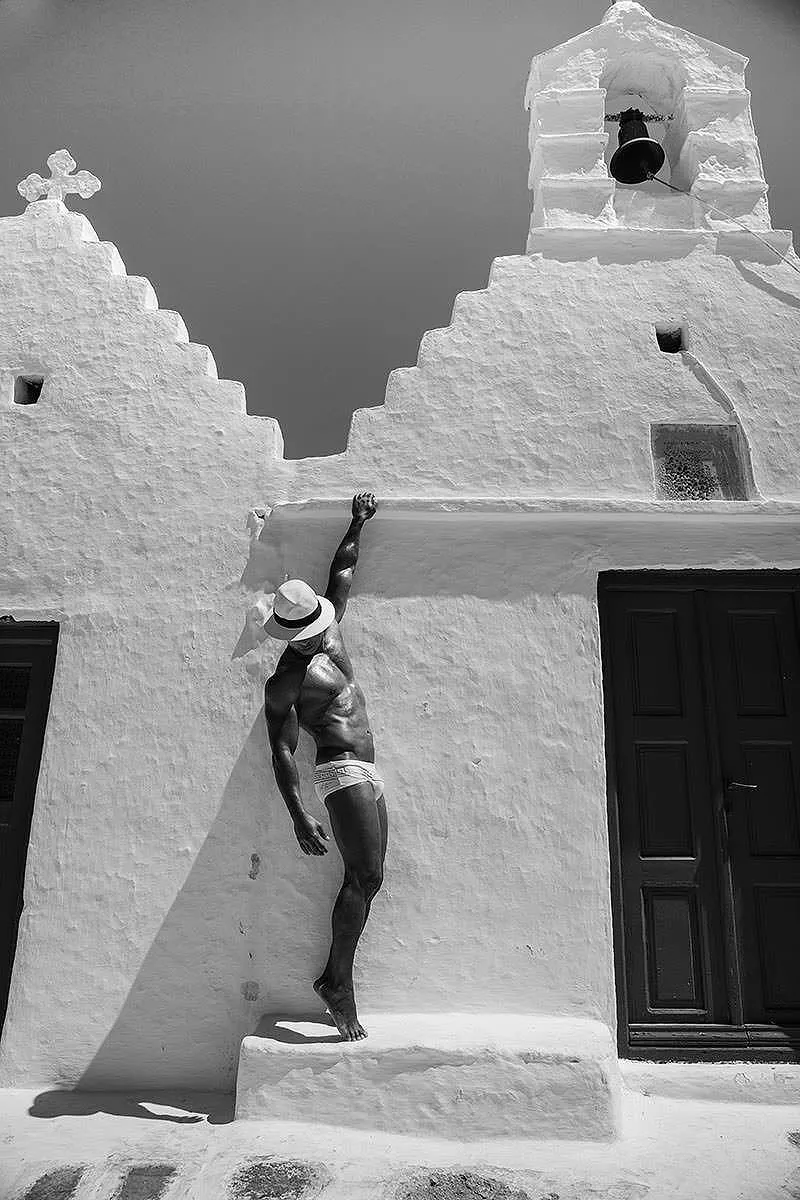 Soft-light athletic male pool portrait moment in Mykonos, Greece