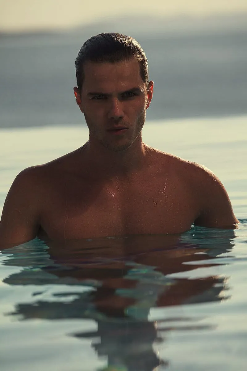 Soft-light male infinity pool portrait frame in Mykonos, Greece