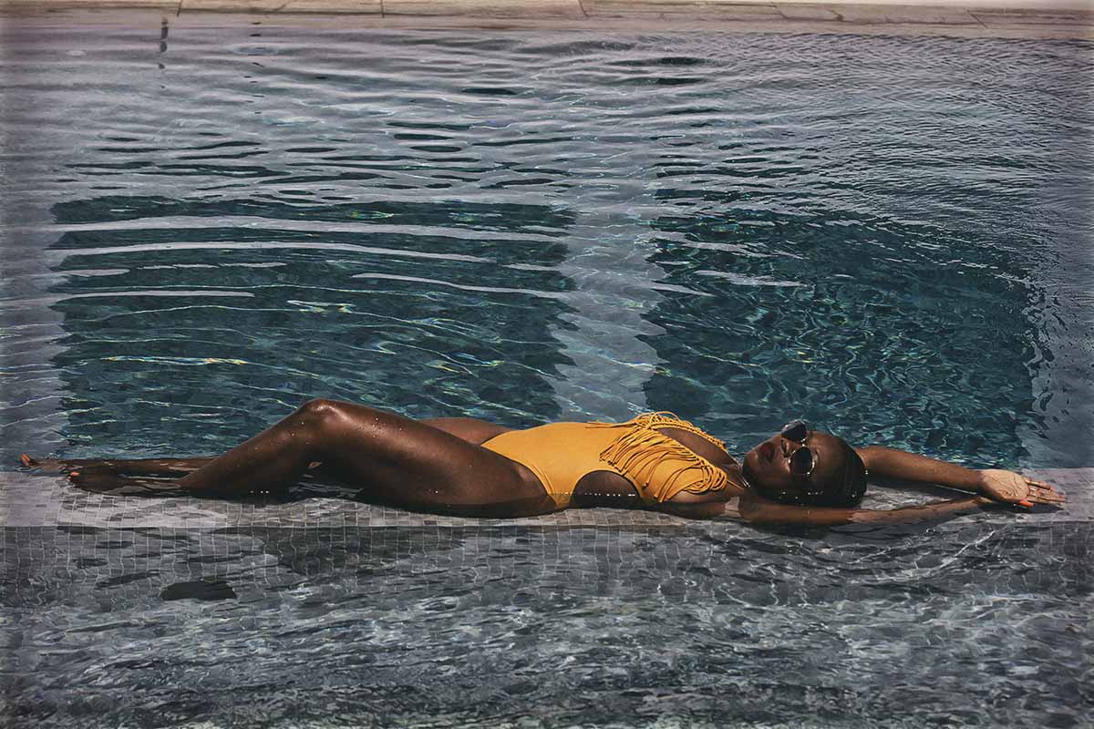 Soft-light male poolside portrait moment in Mykonos, Greece