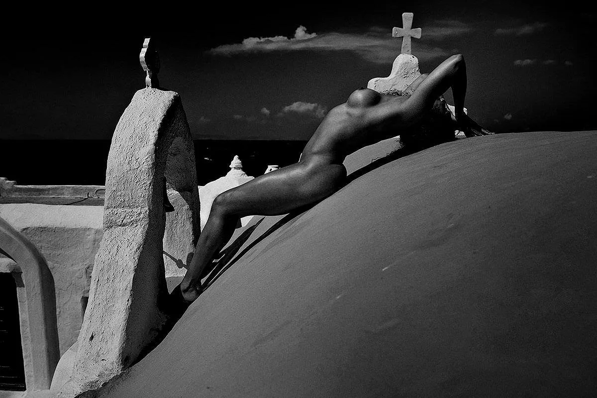Soft-light monochrome dome rooftop portrait frame in Mykonos, Greece