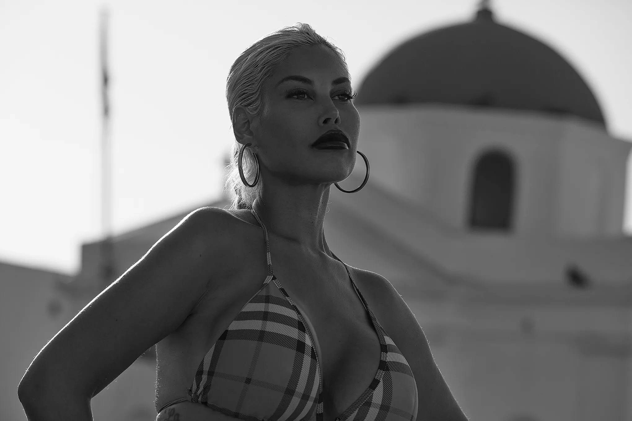 Soft-light monochrome male rocks portrait moment in Mykonos, Greece