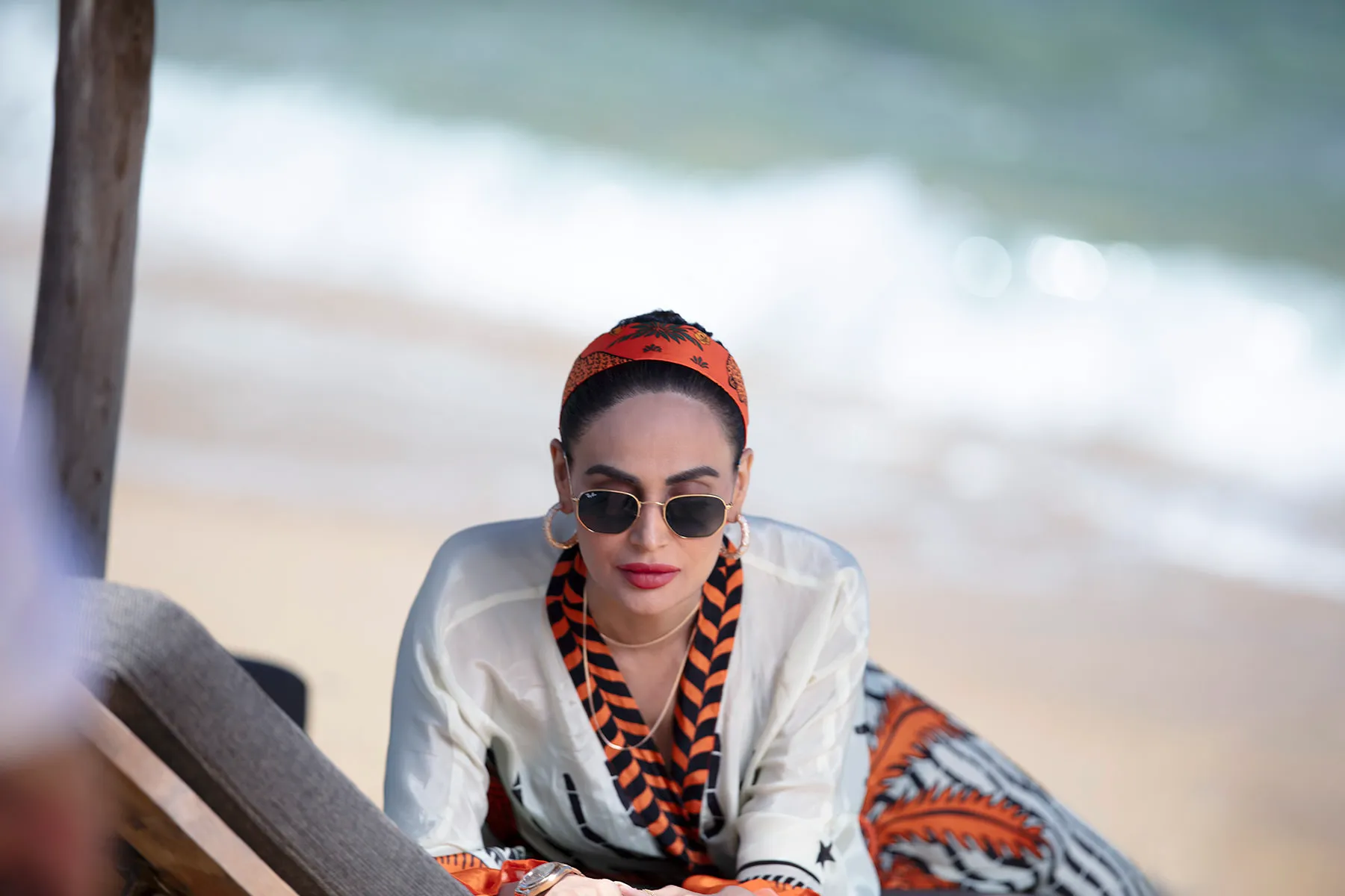Soft-light beach portrait with orange headscarf frame in Mykonos, Greece