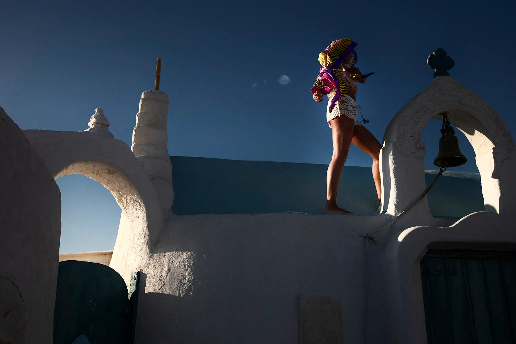Soft-light beach portrait with orange headscarf view in Mykonos, Greece