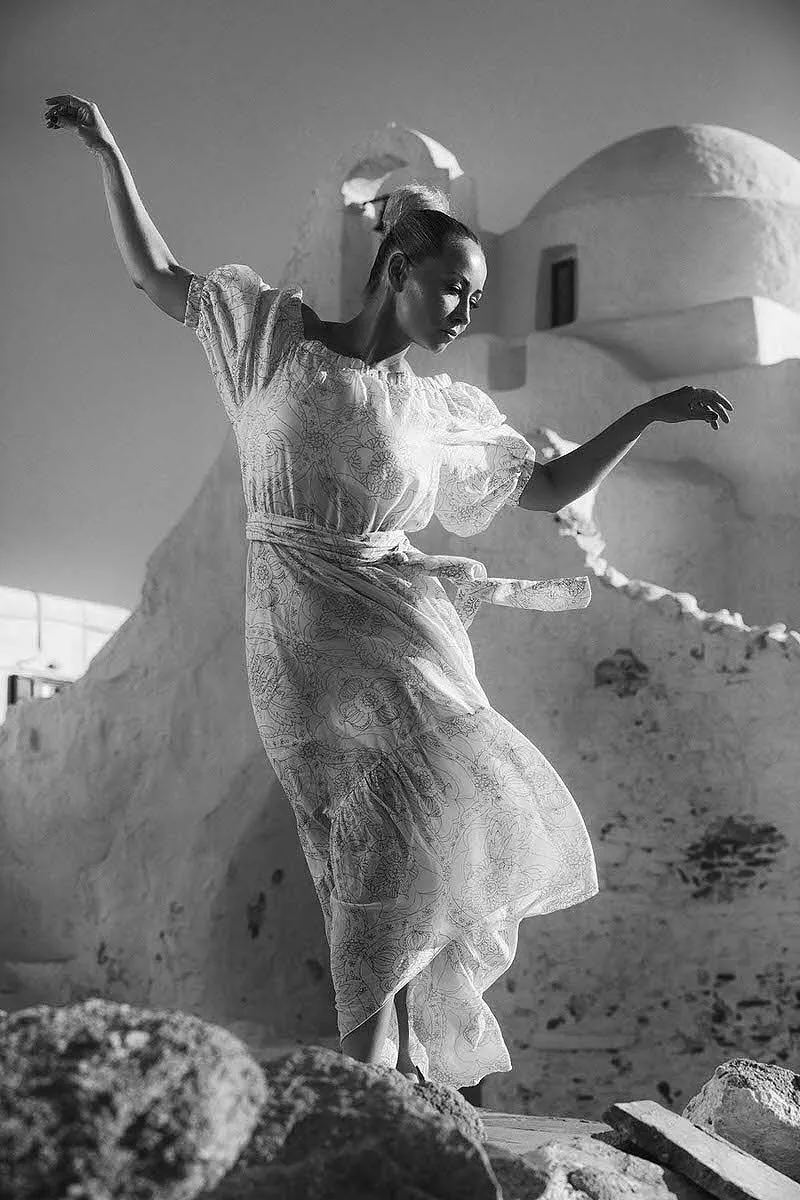 Soft-light red dress poolside portrait moment in Mykonos, Greece