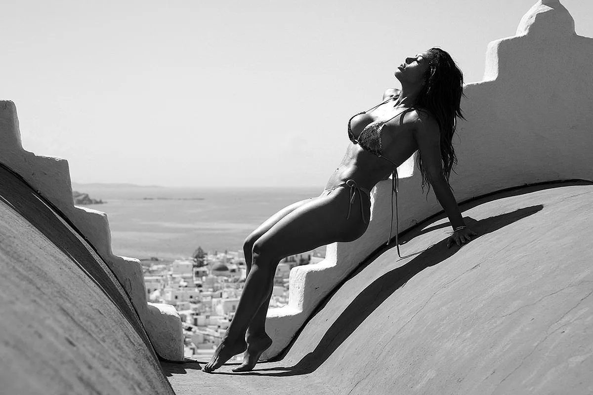 Soft-light rooftop sunset curly portrait moment in Mykonos, Greece