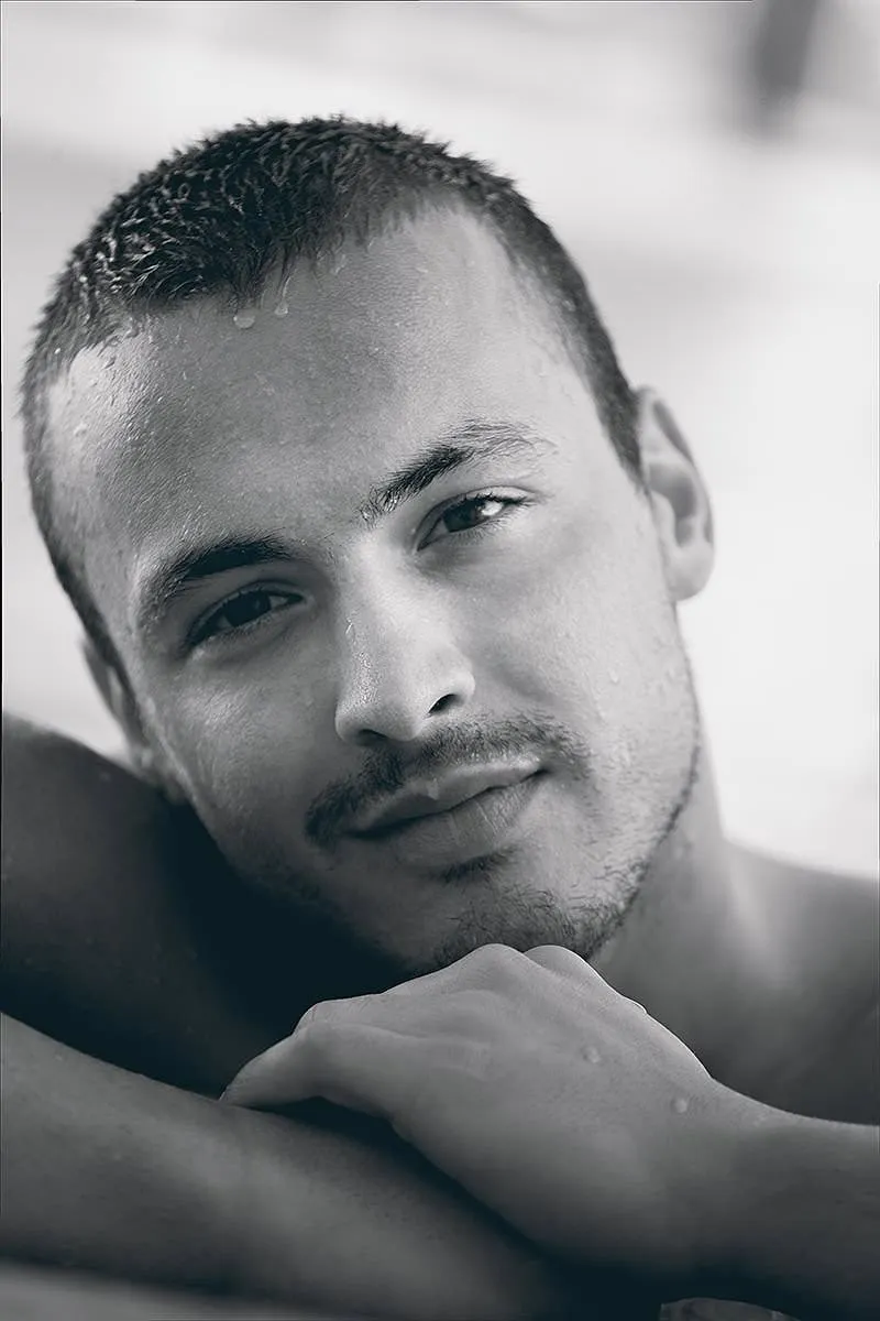 Soft-light wet male monochrome portrait frame in Mykonos, Greece