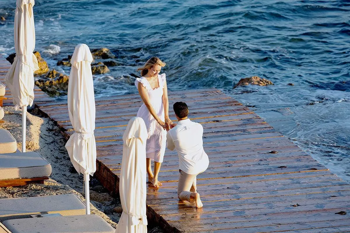 Sunlit beach wedding proposal frame in Mykonos, Greece