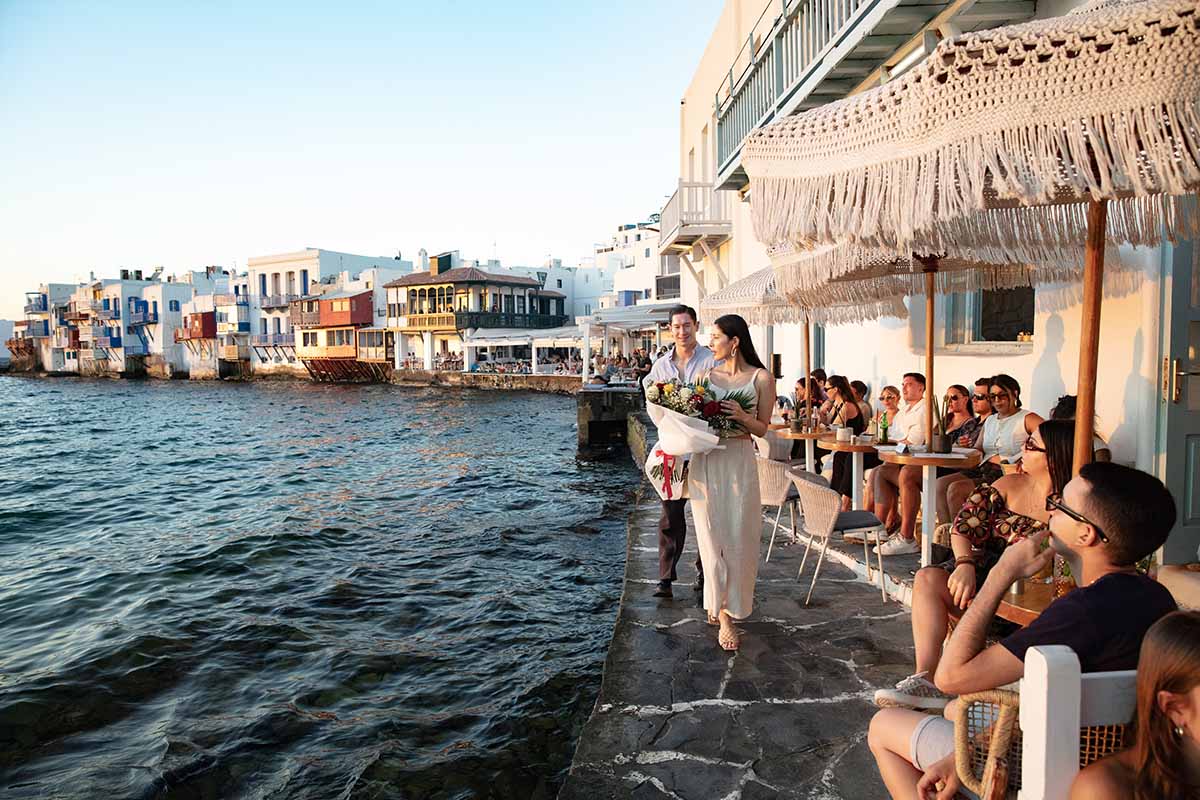 Sunlit candid wedding proposal composition in Mykonos, Greece