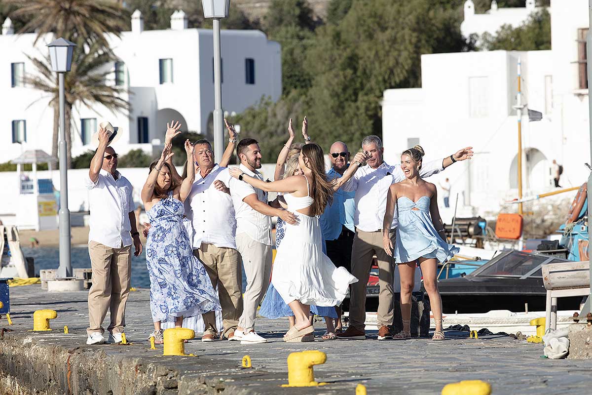 Sunlit rooftop wedding proposal moment in Mykonos, Greece