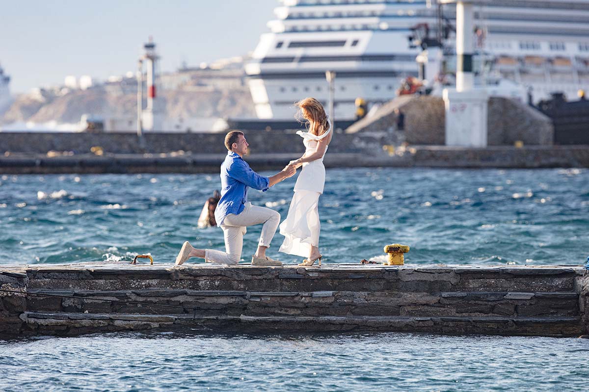Sunlit rooftop wedding proposal composition in Mykonos, Greece