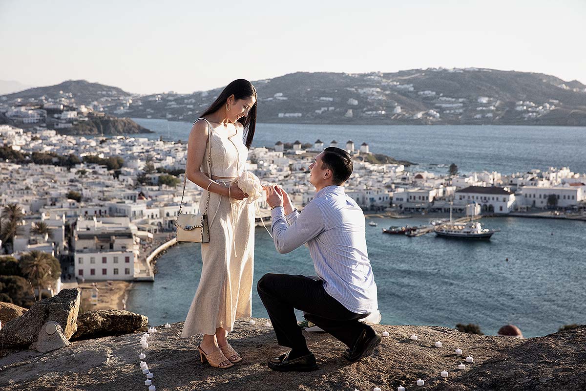 Sunlit rooftop wedding proposal shot in Mykonos, Greece
