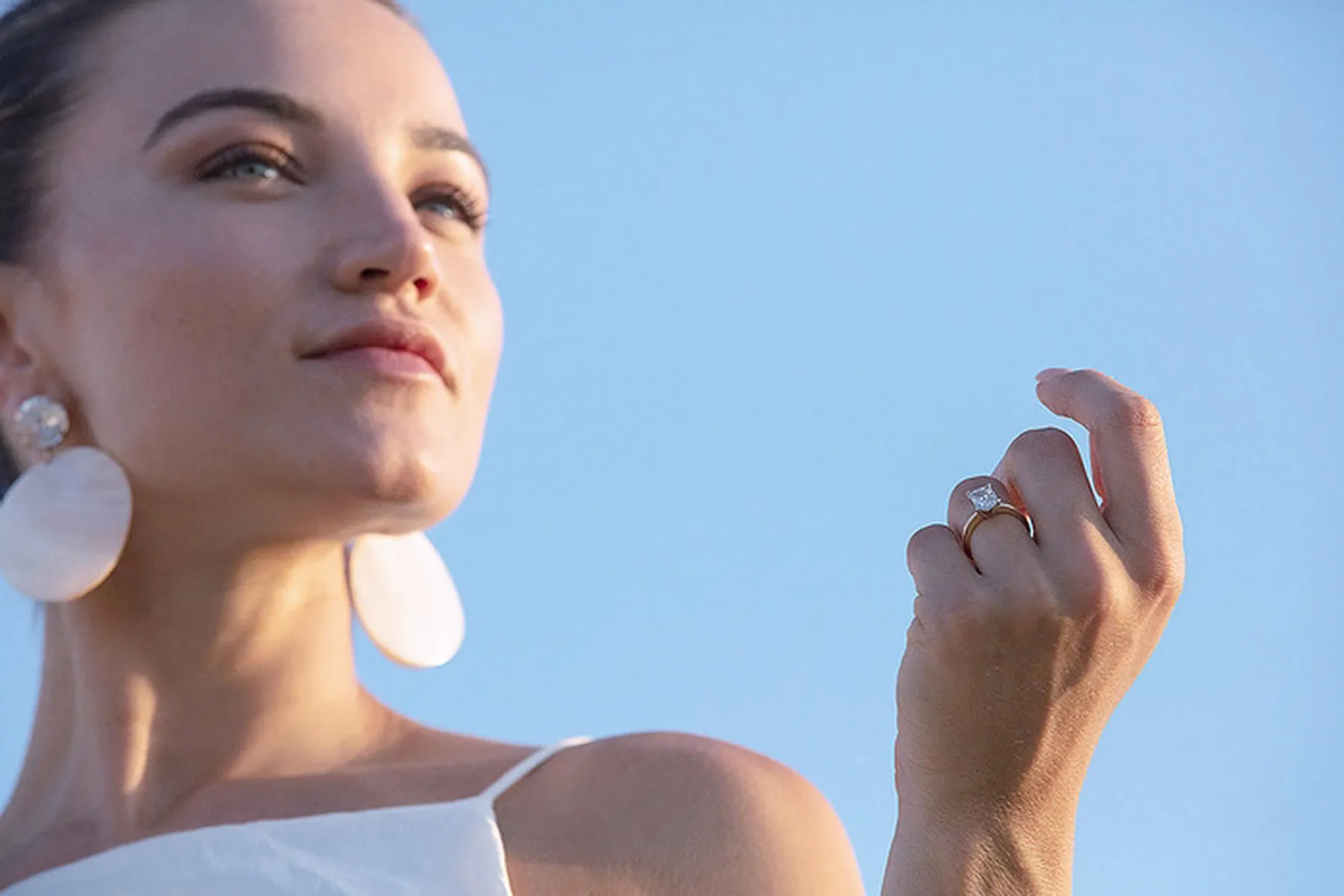 Sunlit stone arch wedding proposal moment in Mykonos, Greece