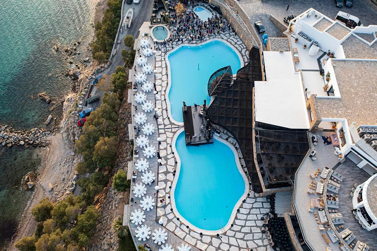 Sunlit aerial drone wedding photography by the Aegean sea, in Mykonos, Greece