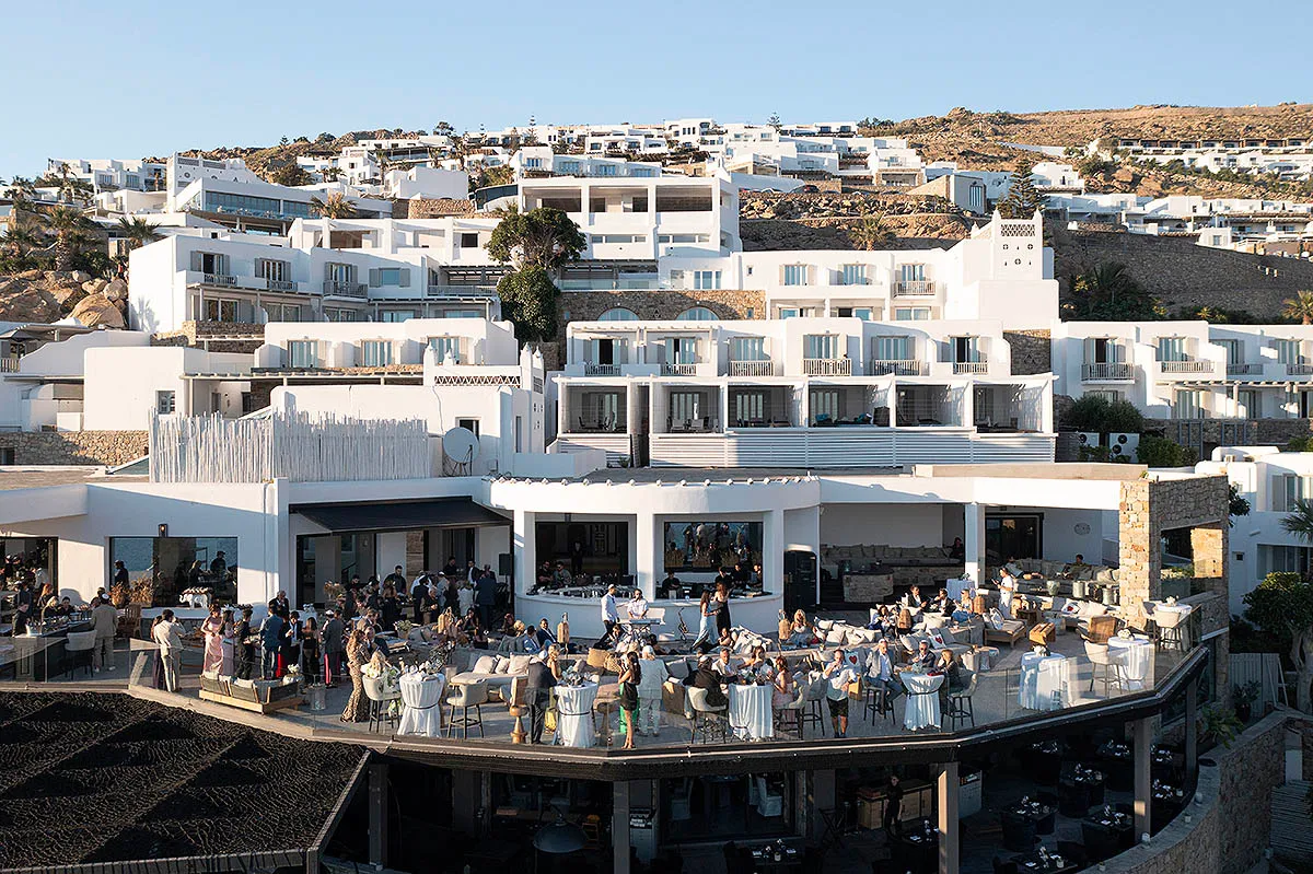 Sunlit aerial drone wedding photography on a sandy beach, in Mykonos, Greece