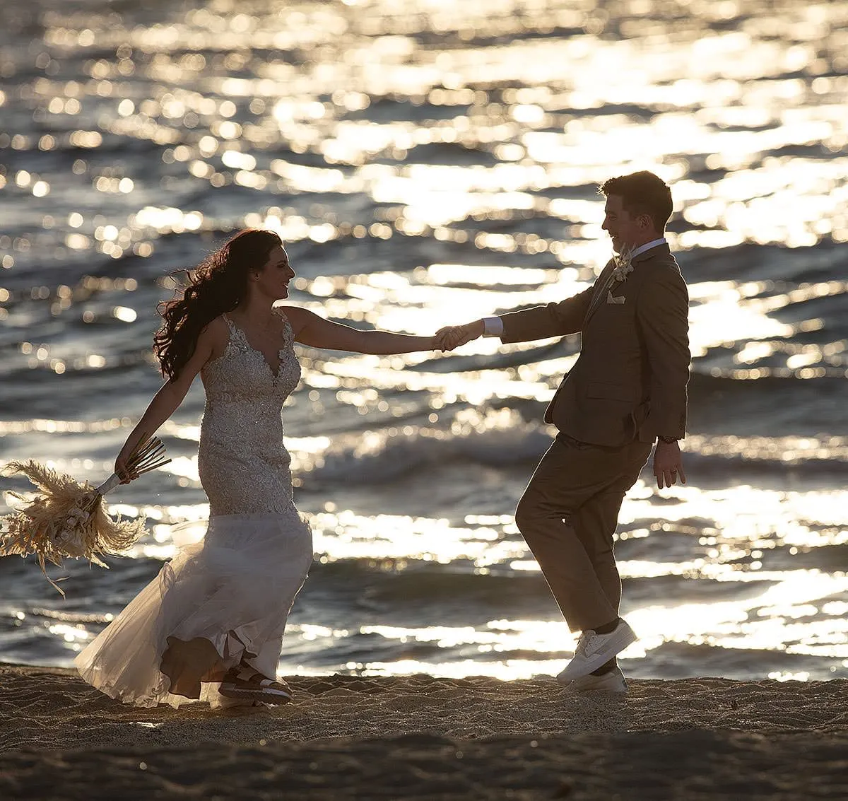 Sunlit beach wedding photography on a sandy beach, in Mykonos, Greece