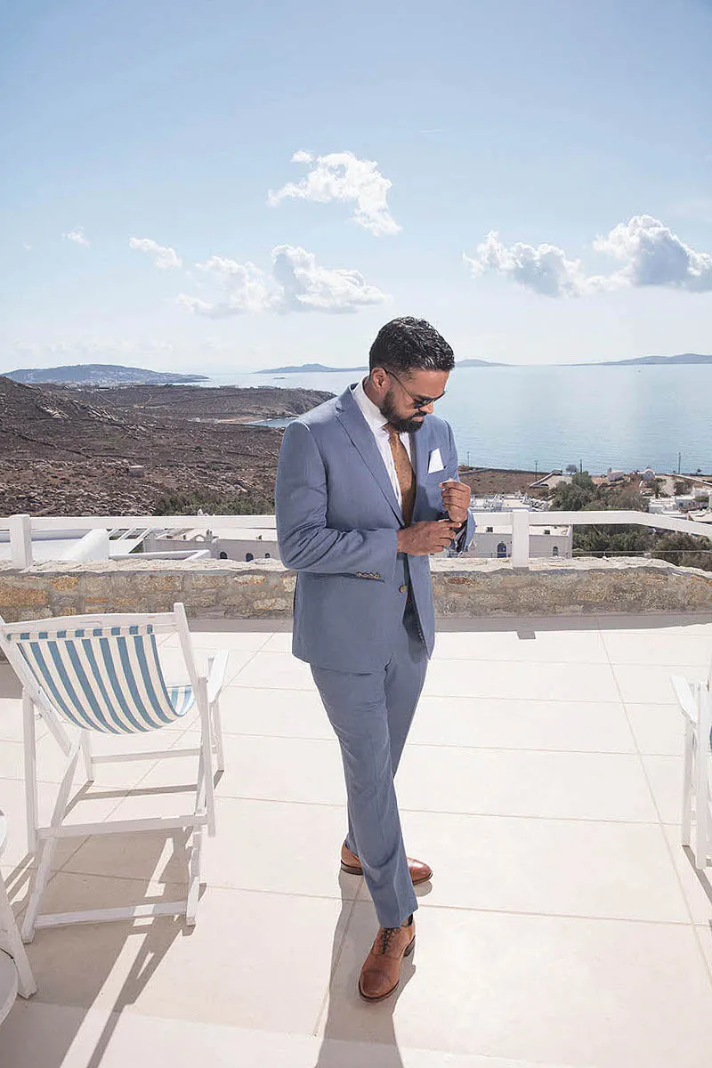 Sunlit blue dome chapel wedding photography by the Aegean sea, in Mykonos, Greece