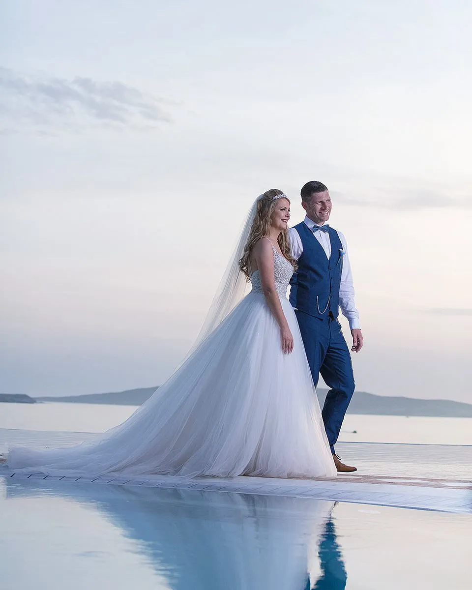 Sunlit blue dome chapel wedding photography on a Cycladic terrace, in Mykonos, Greece
