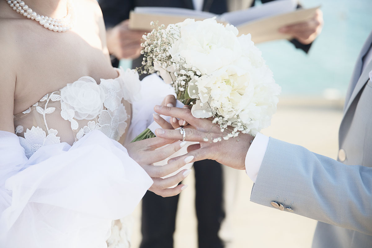 Sunlit bridal glow wedding photography by a blue dome, in Mykonos, Greece