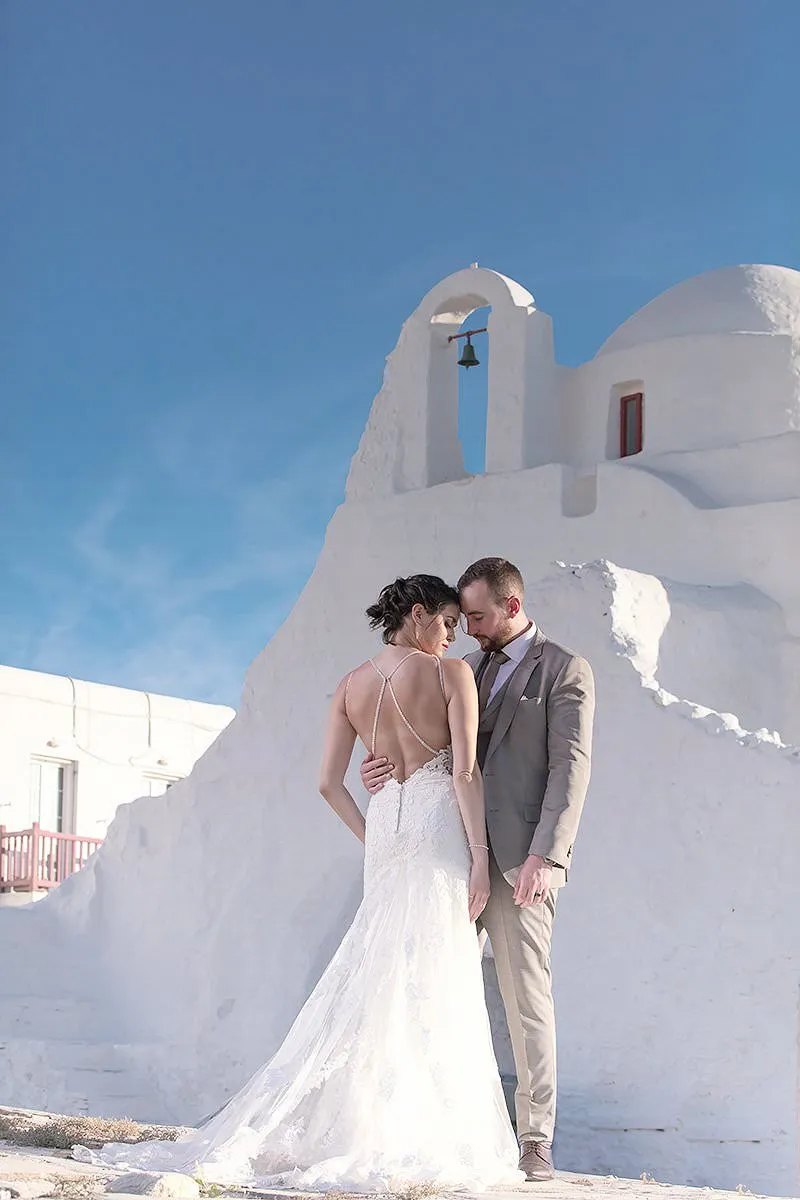 Sunlit altar ceremony wedding photography by a blue dome, in Mykonos, Greece