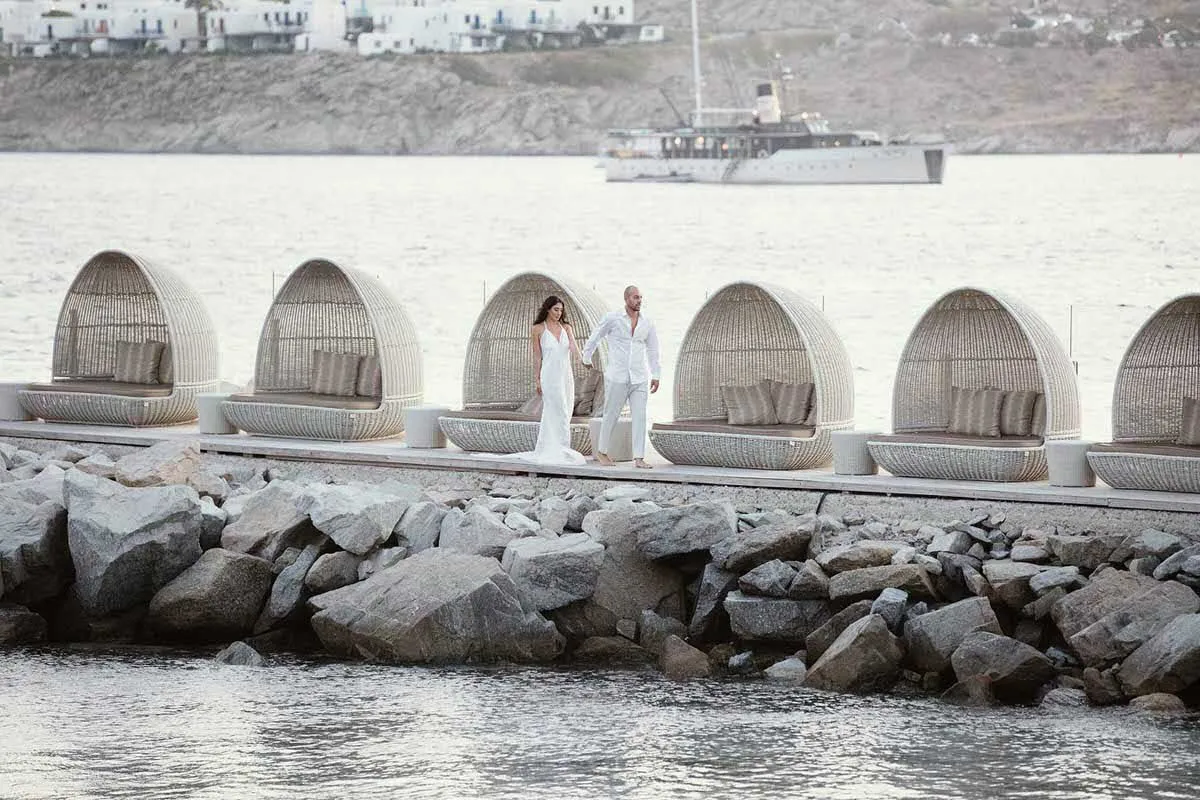 Sunlit chapel wedding photography on a sandy beach, in Mykonos, Greece