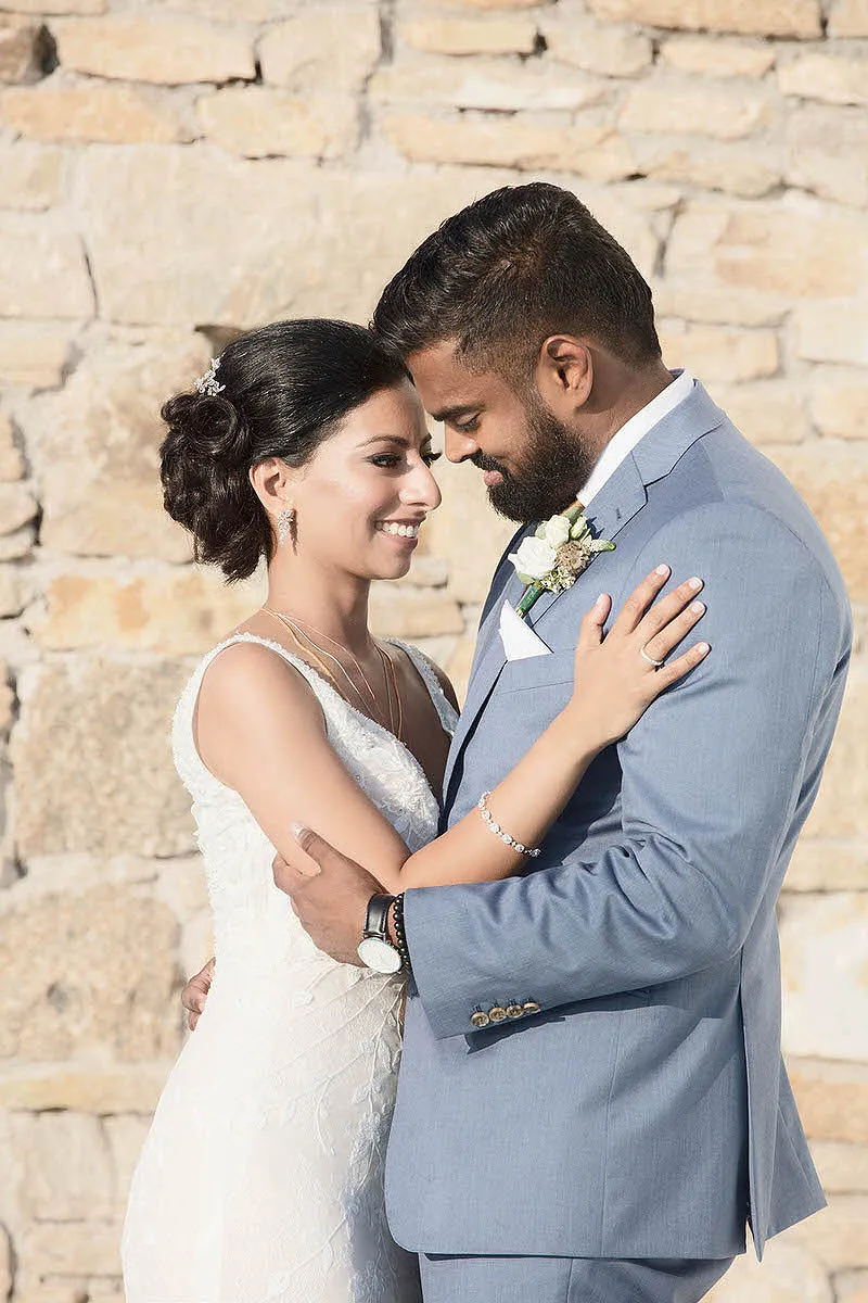 Sunlit clifftop wedding photography by the Aegean sea, in Mykonos, Greece