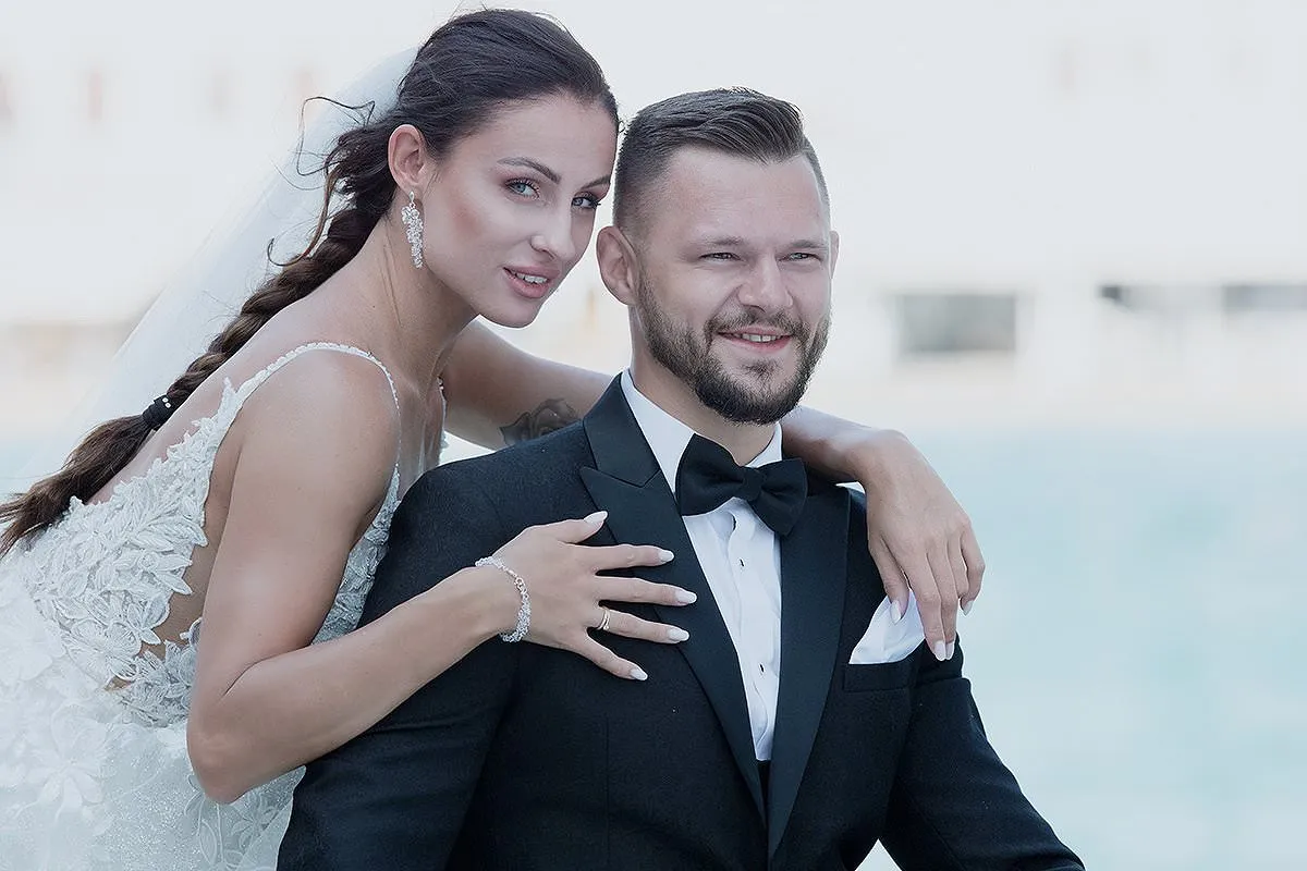Sunlit clifftop wedding photography on a sandy beach, in Mykonos, Greece