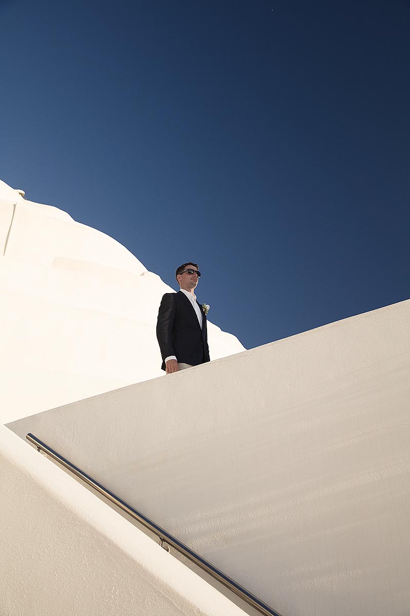 Sunlit Cycladic vow wedding photography on a sandy beach, in Mykonos, Greece