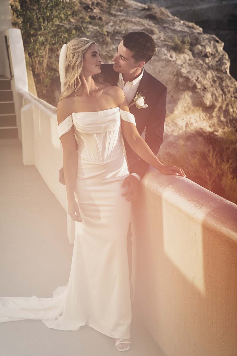 Sunlit Cycladic vow wedding photography by a blue dome, in Mykonos, Greece