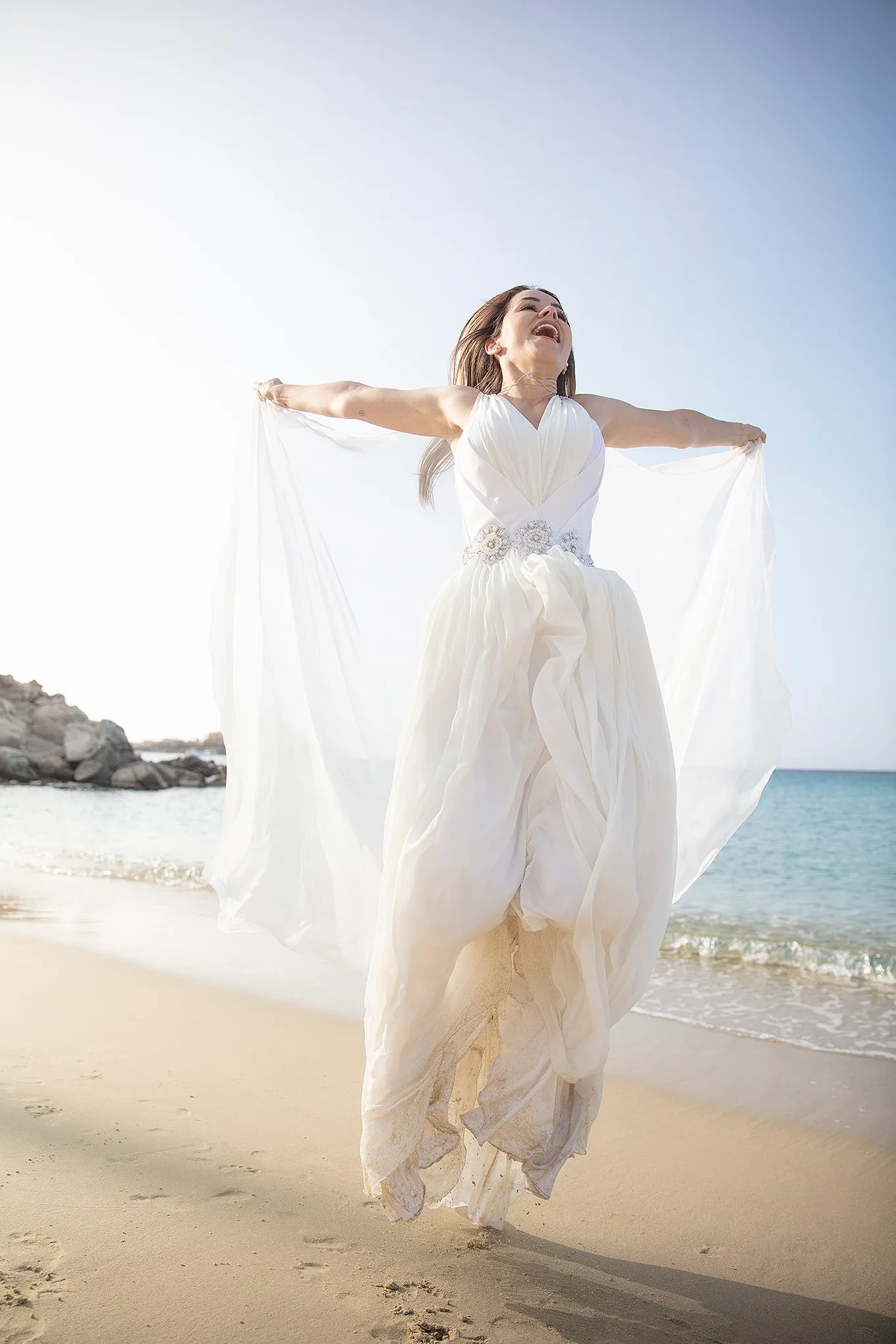 Sunlit documentary wedding photography by the Aegean sea, in Mykonos, Greece