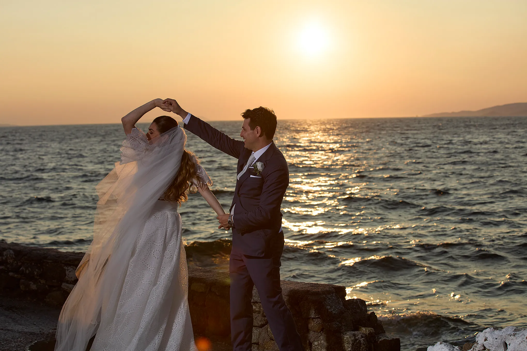 Sunlit documentary wedding photography on a sandy beach, in Mykonos, Greece