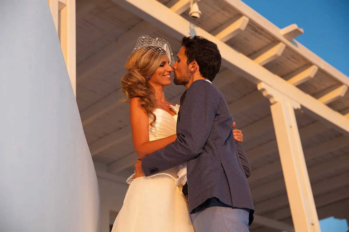 Sunlit editorial couple wedding photography on a Cycladic terrace, in Mykonos, Greece