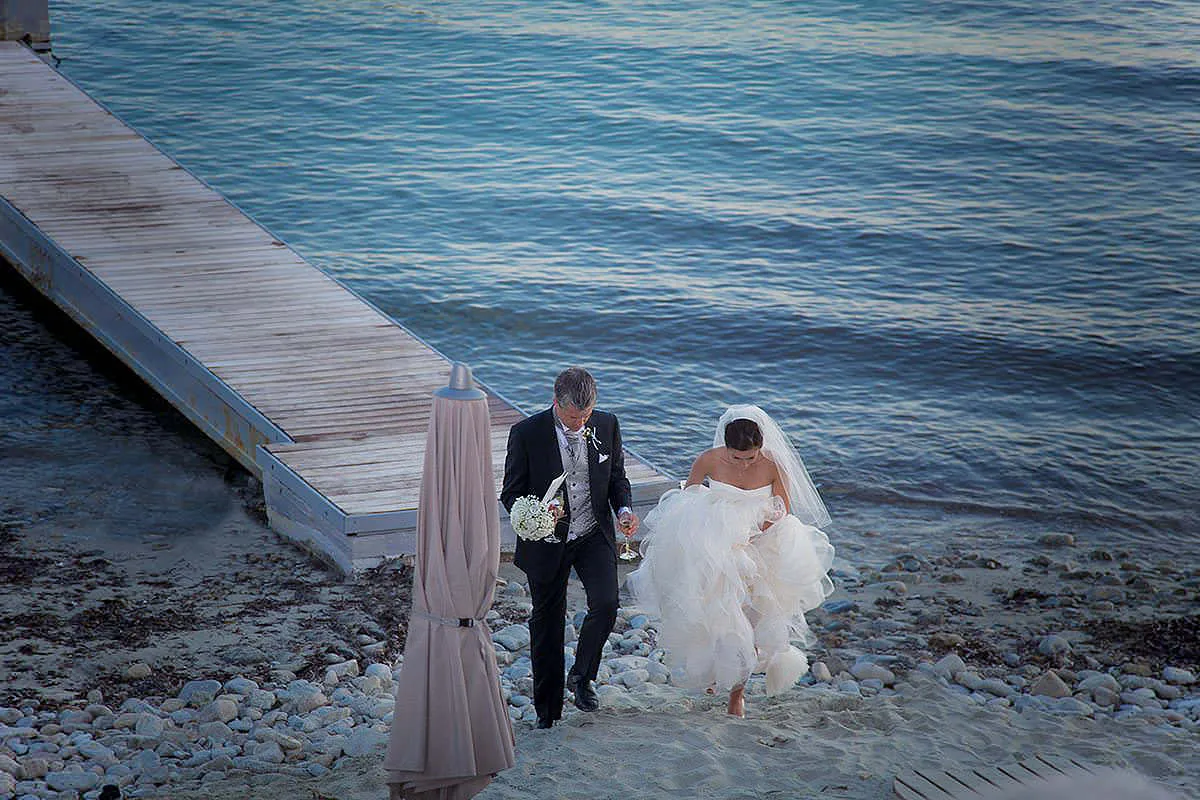 Sunlit groom portrait wedding photography at a whitewashed chapel, in Mykonos, Greece