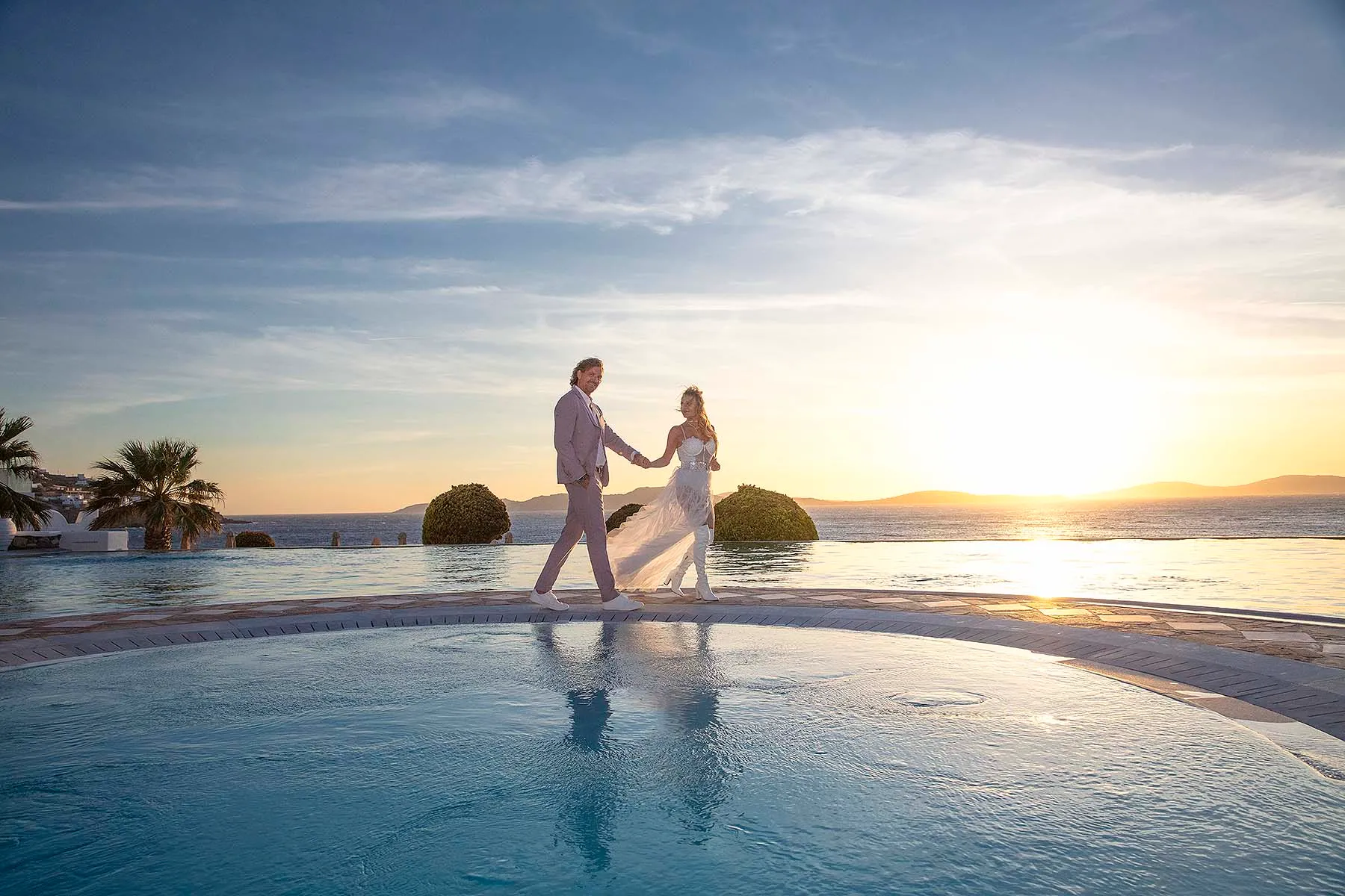 Sunlit harbor wedding photography by the Aegean sea, in Mykonos, Greece