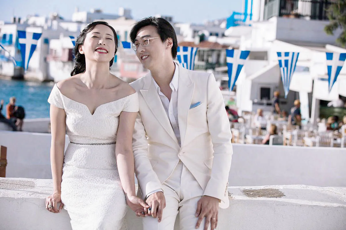 Sunlit intimate wedding photography on a sandy beach, in Mykonos, Greece