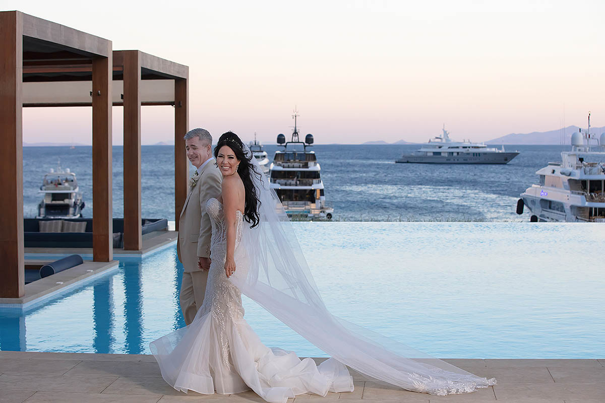 Sunlit luxe resort wedding photography on a sandy beach, in Mykonos, Greece
