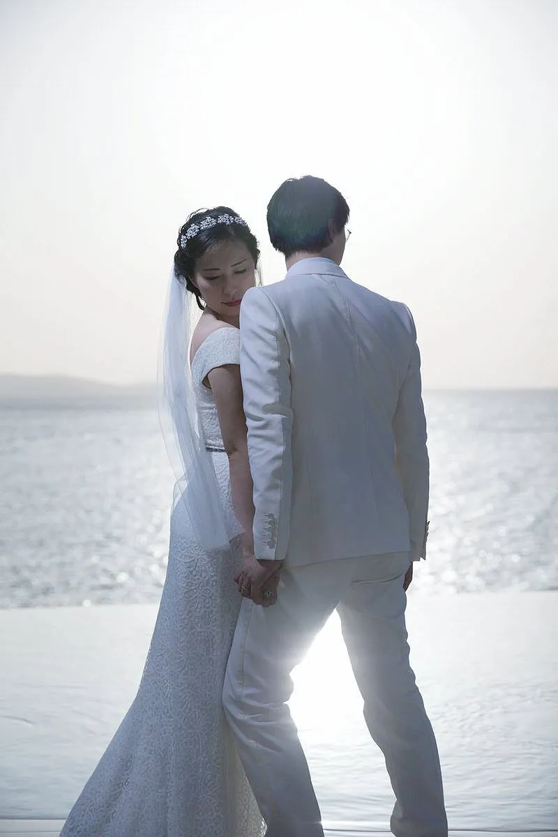 Sunlit monochrome wedding photography at a whitewashed chapel, in Mykonos, Greece