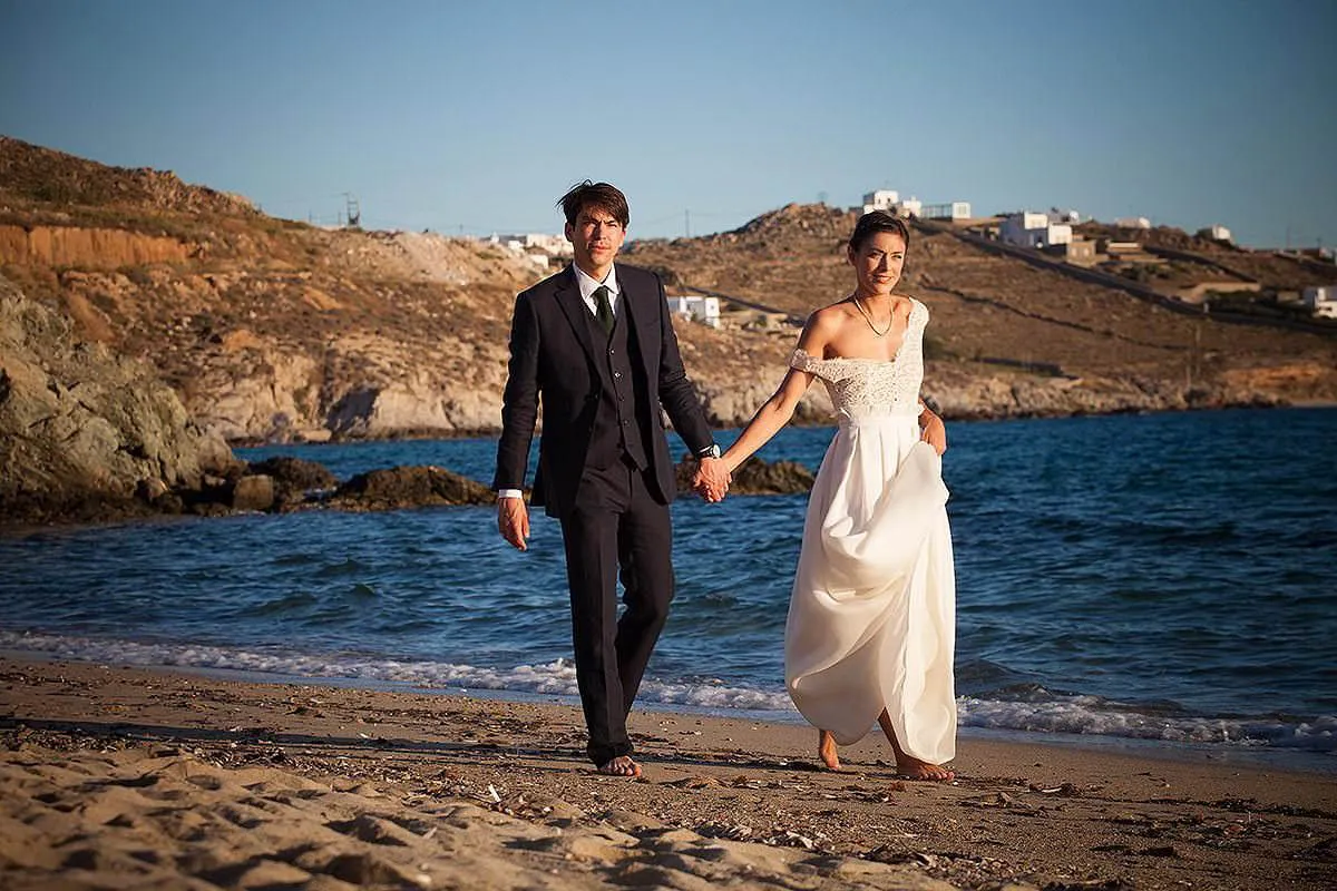 Sunlit romantic wedding photography at a whitewashed chapel, in Mykonos, Greece