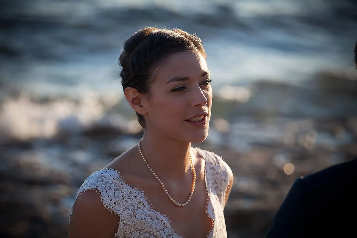 Sunlit romantic wedding photography on a sandy beach, in Mykonos, Greece