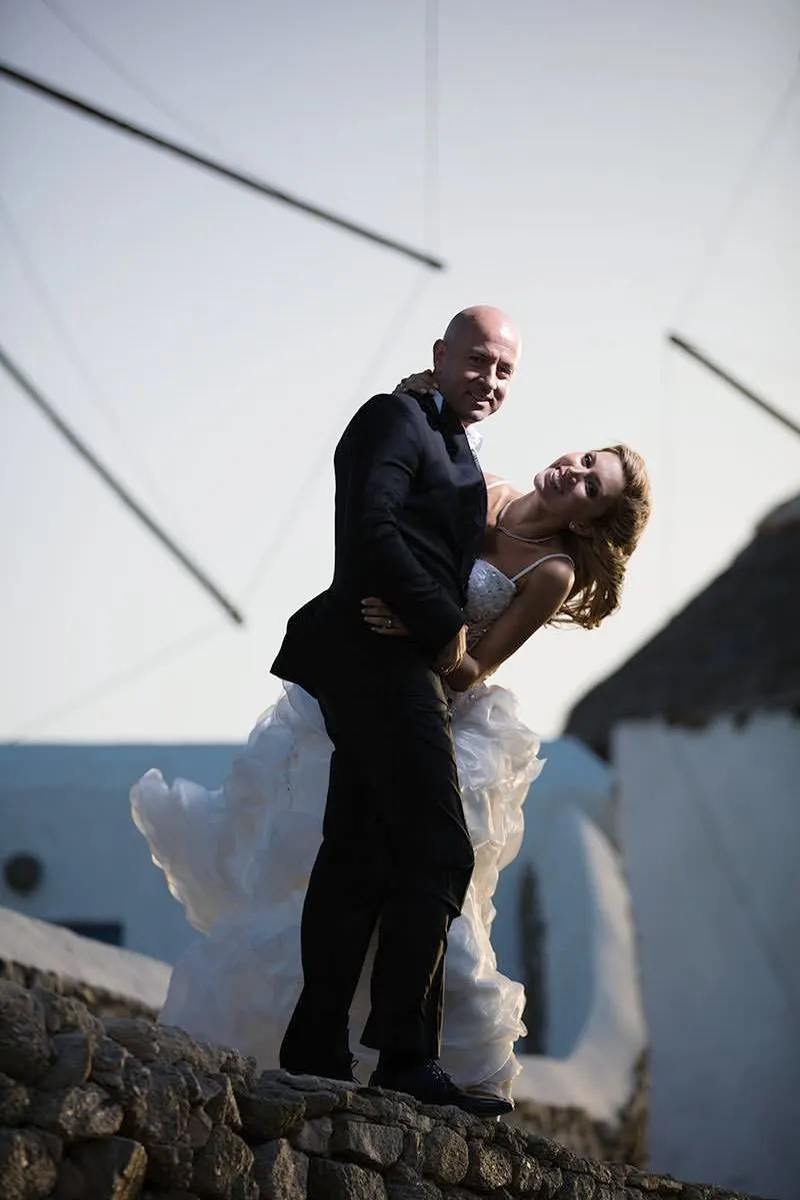 Sunlit villa wedding photography by a blue dome, in Mykonos, Greece